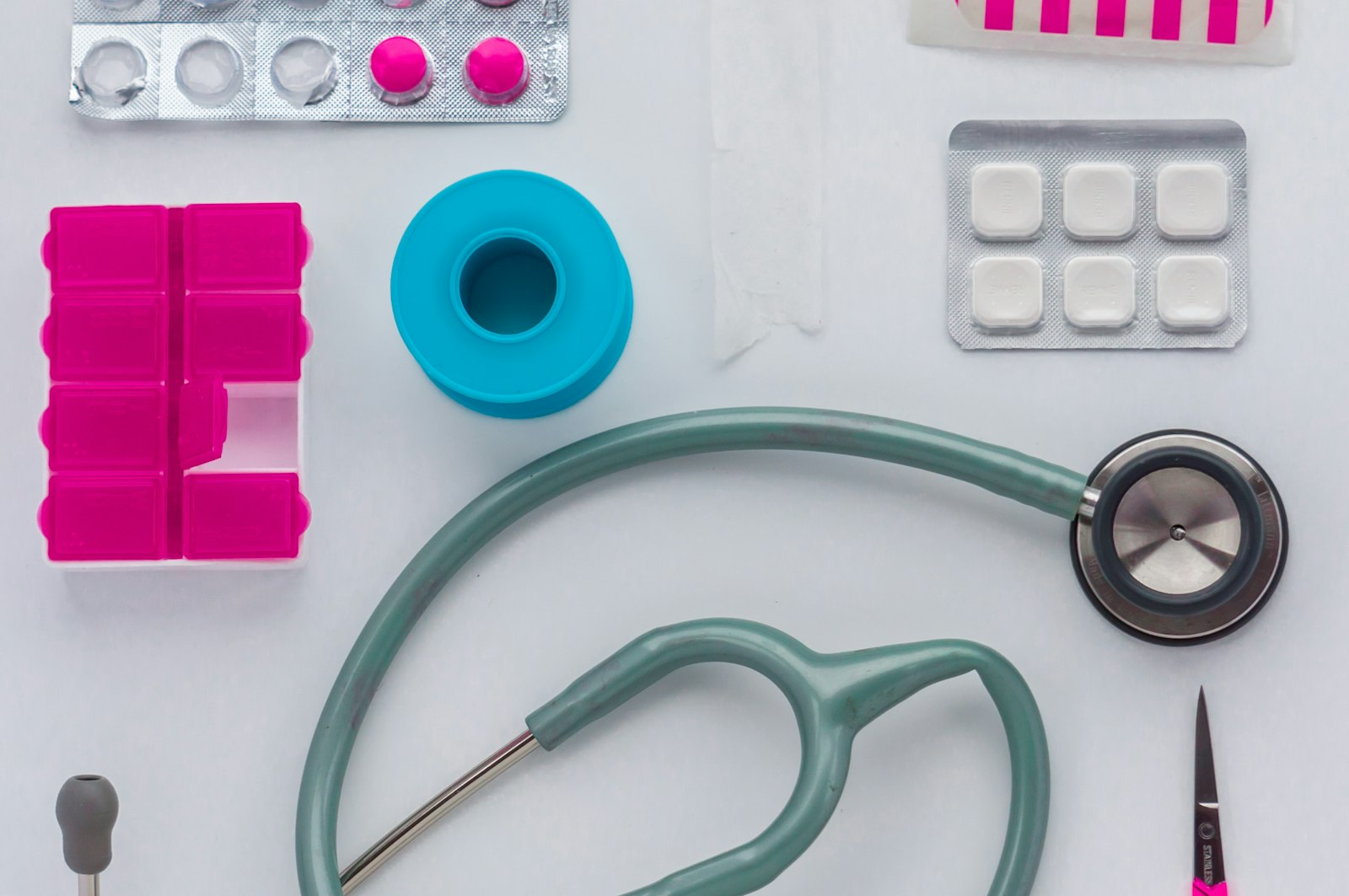 A stethoscope and medical supplies laid out on a table