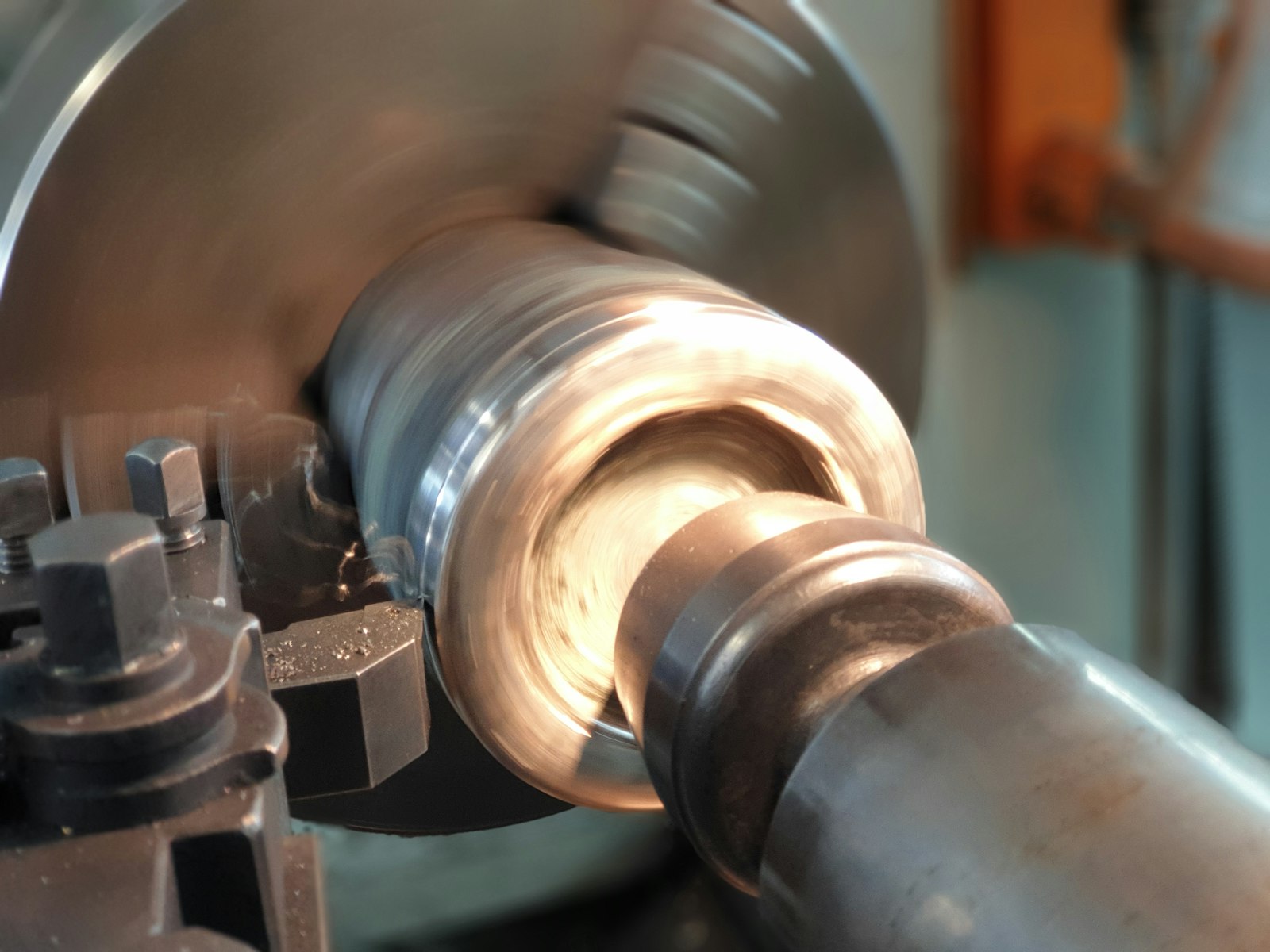Close-up of a metal workpiece being turned on a lathe